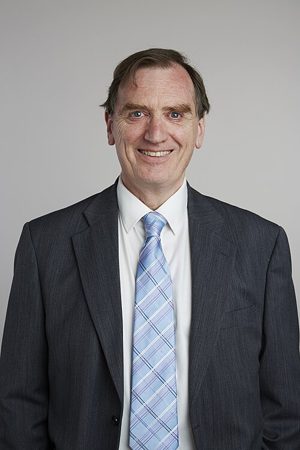 Clifford Cocks in a suit and tie