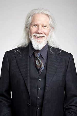 Whitfield Diffie, with long white hair and a beard, in a suit