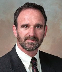 Martin Hellman, with a beard, in a suit and tie