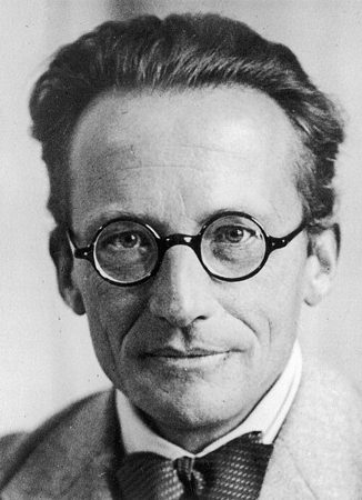 Erwin Schrödinger in round glasses, in a black and white portrait