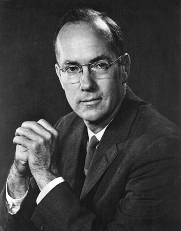 Charles Townes in glasses, hands clasped